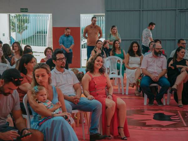 Famílias assistindo a uma apresentação na escola